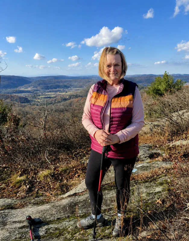 Catherine Herman, Hudson Valley watercolor artist, standing outdoors during a hike, inspired by natural light and regional landscapes of the Catskills and Berkshire Mountains